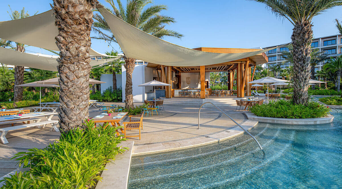 Tables, palm trees and pool