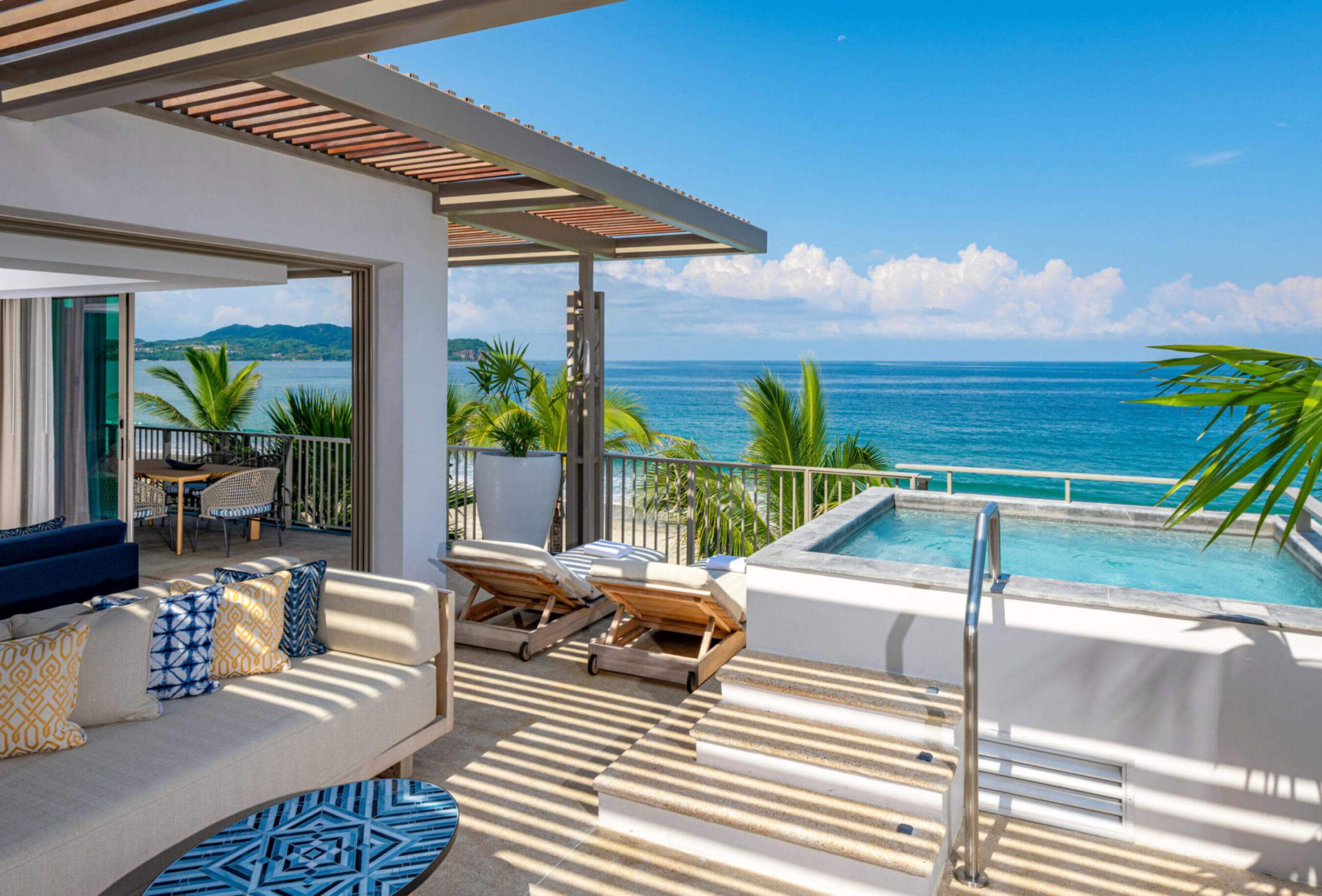 A balcony with small swimming pool on right side and with a beautiful view of ocean