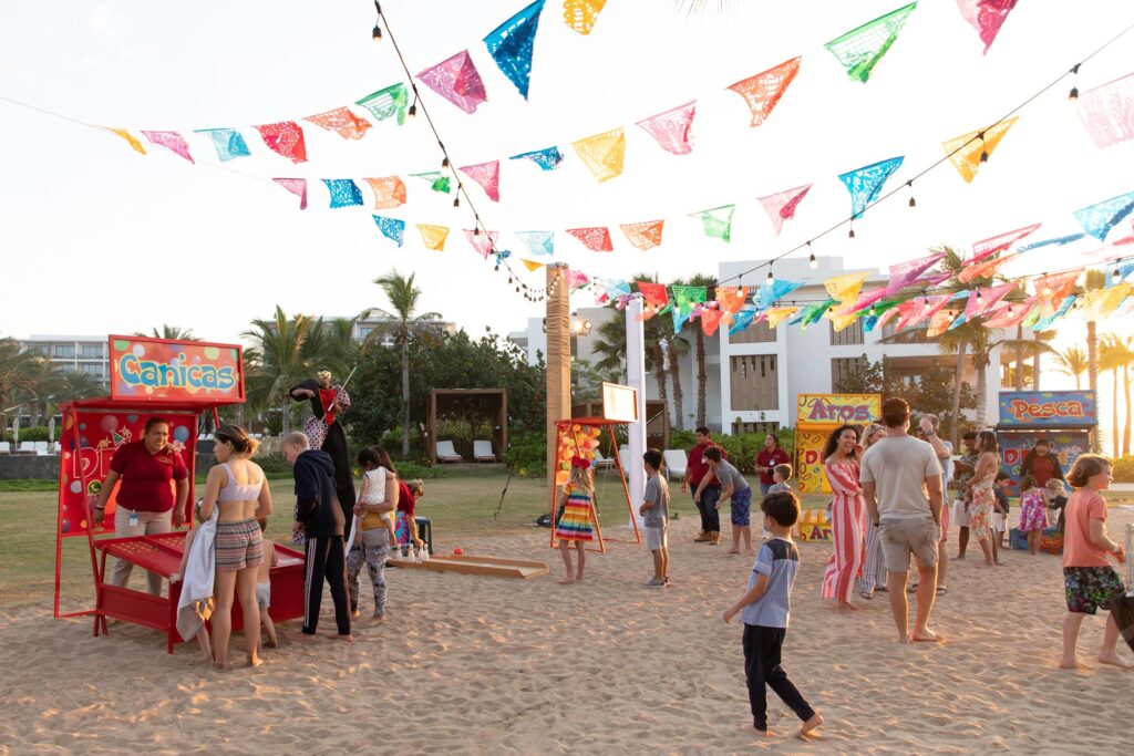 People are celebrating their festival happily while enjoying the sand on the beach.