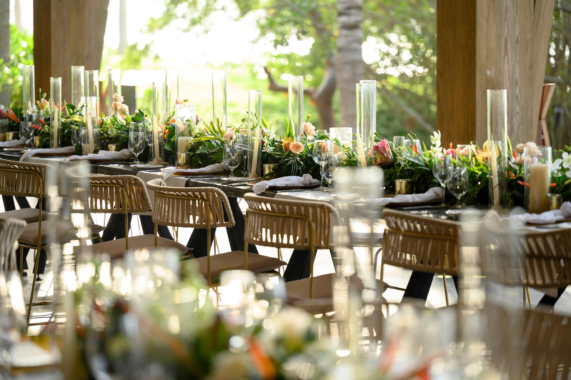 A dining table is elegantly decorated with flowers and candles for the celebration.