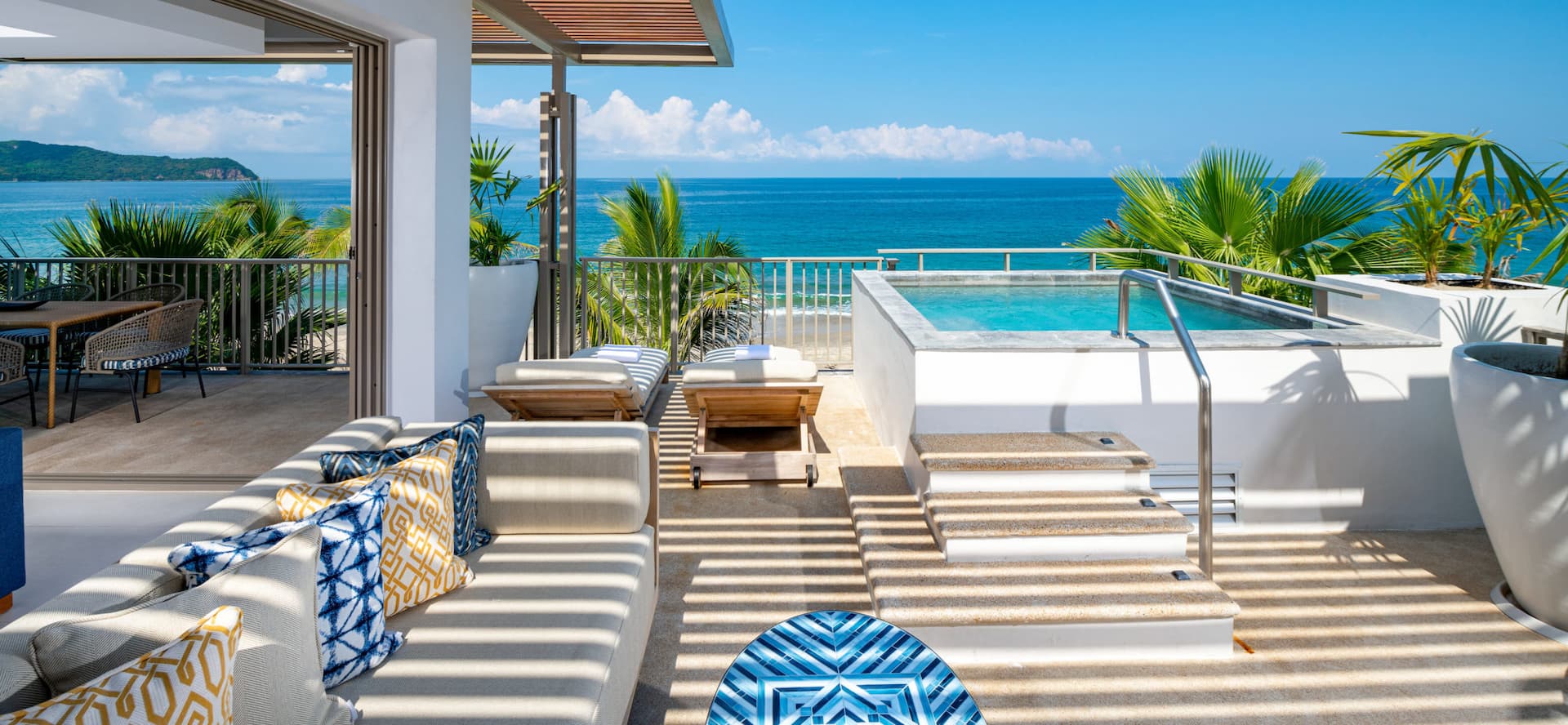 The house showcases a corner terrace pool overlooking a stunning ocean panorama.