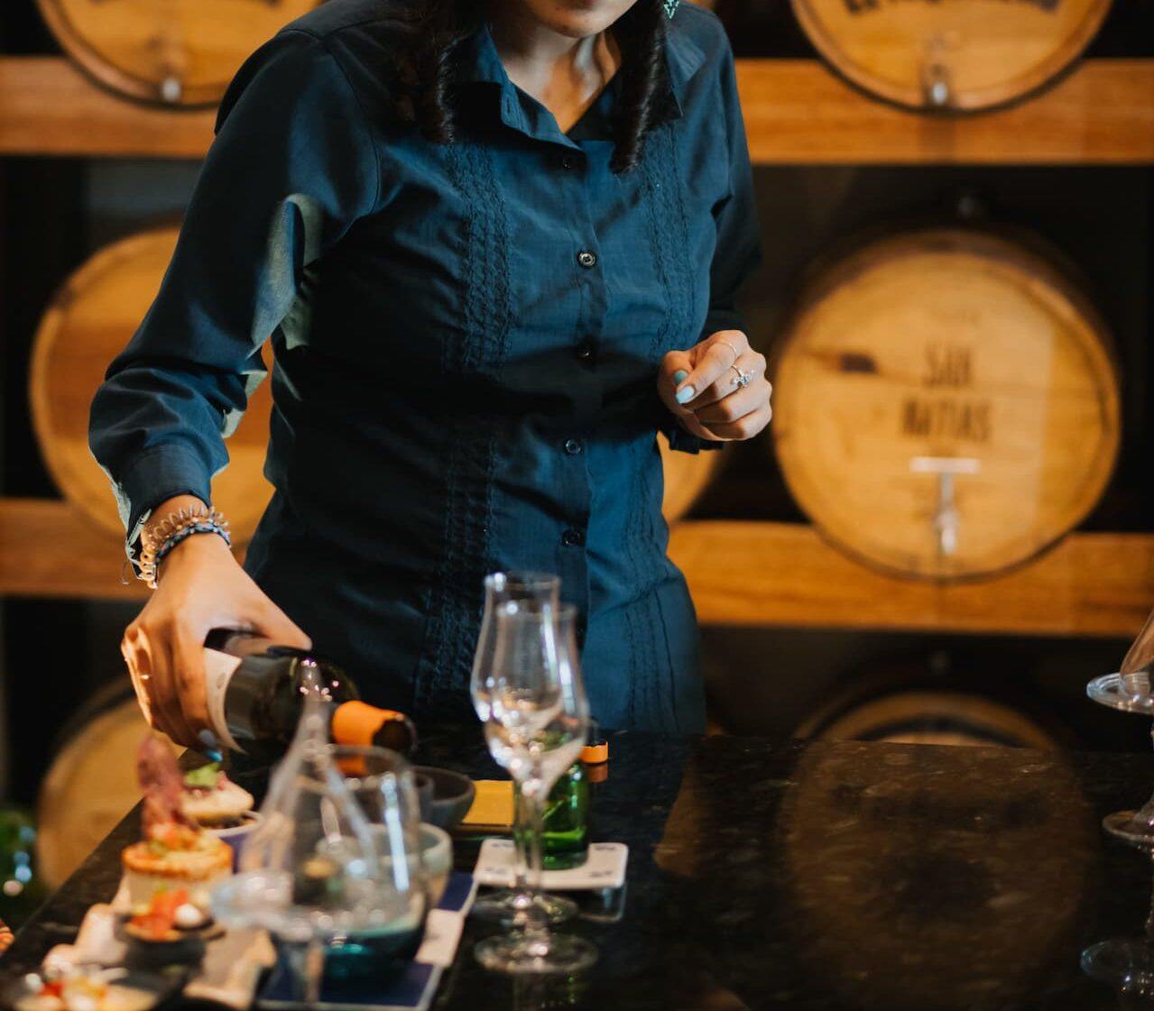 A lady serving wine in glass