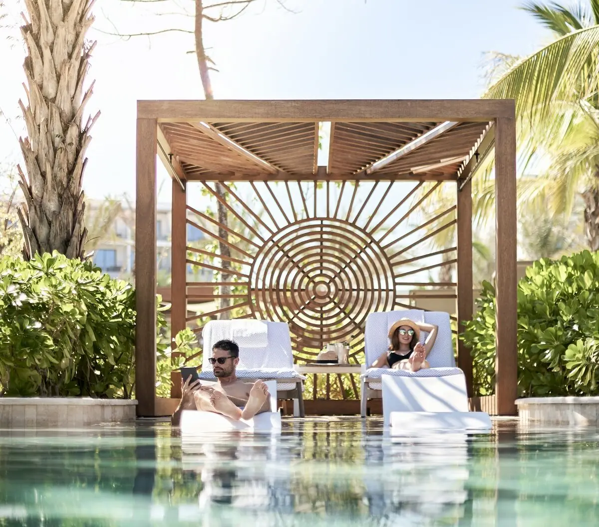 Couple relaxing by the pool