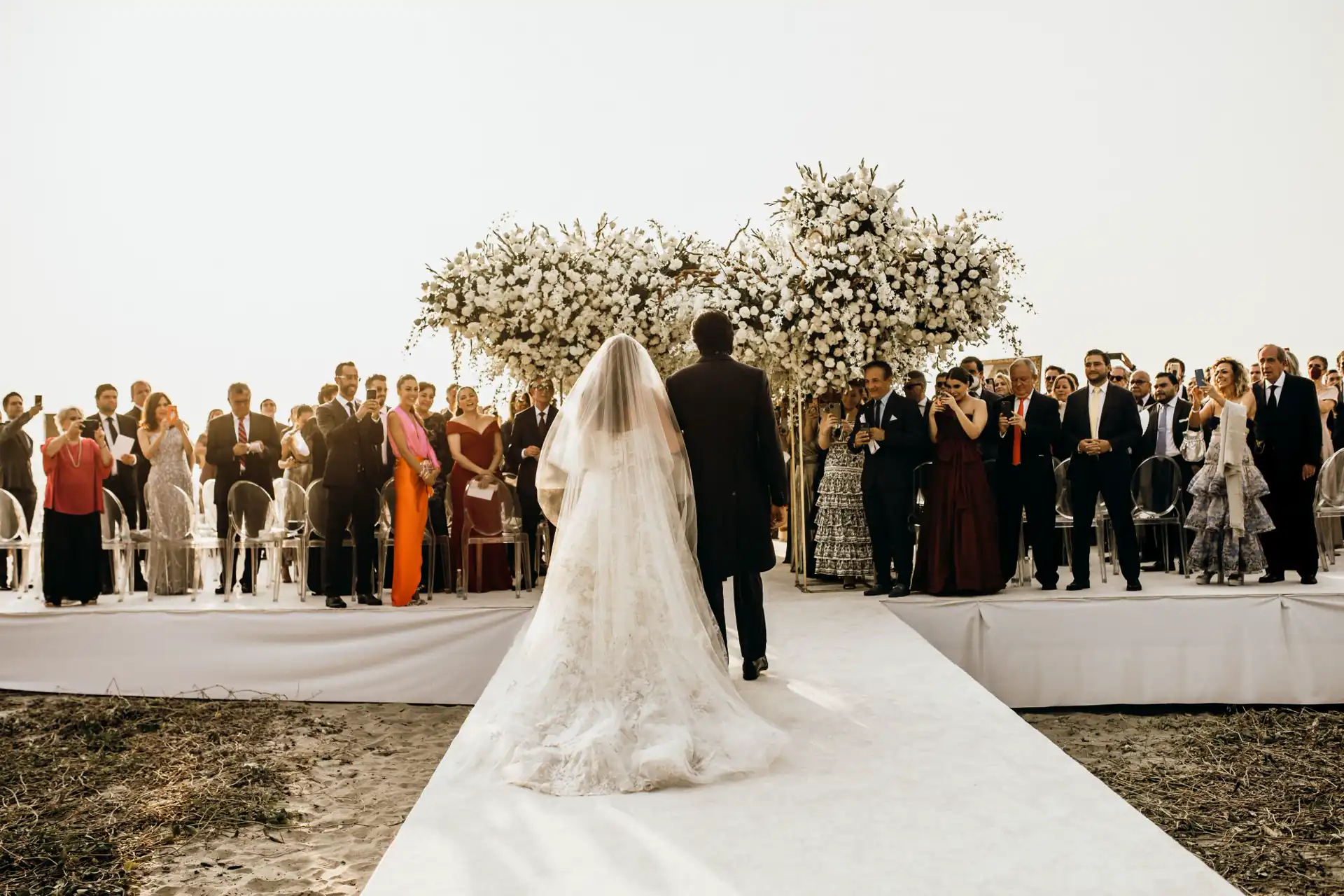 Guests capture moments as witnesses to the bride and groom's wedding ceremony.