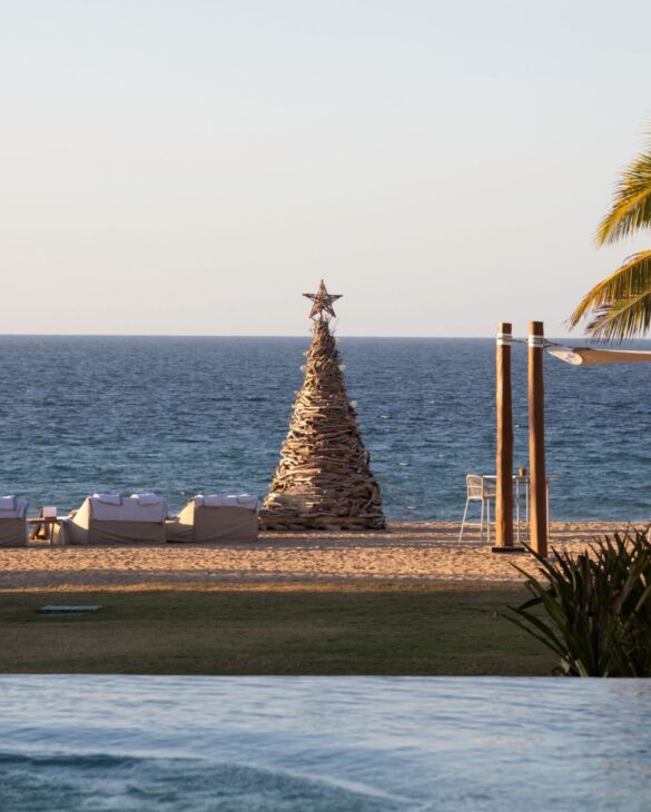 A well-arranged seaside lounge with a Christmas tree, offering an incredible ocean view.