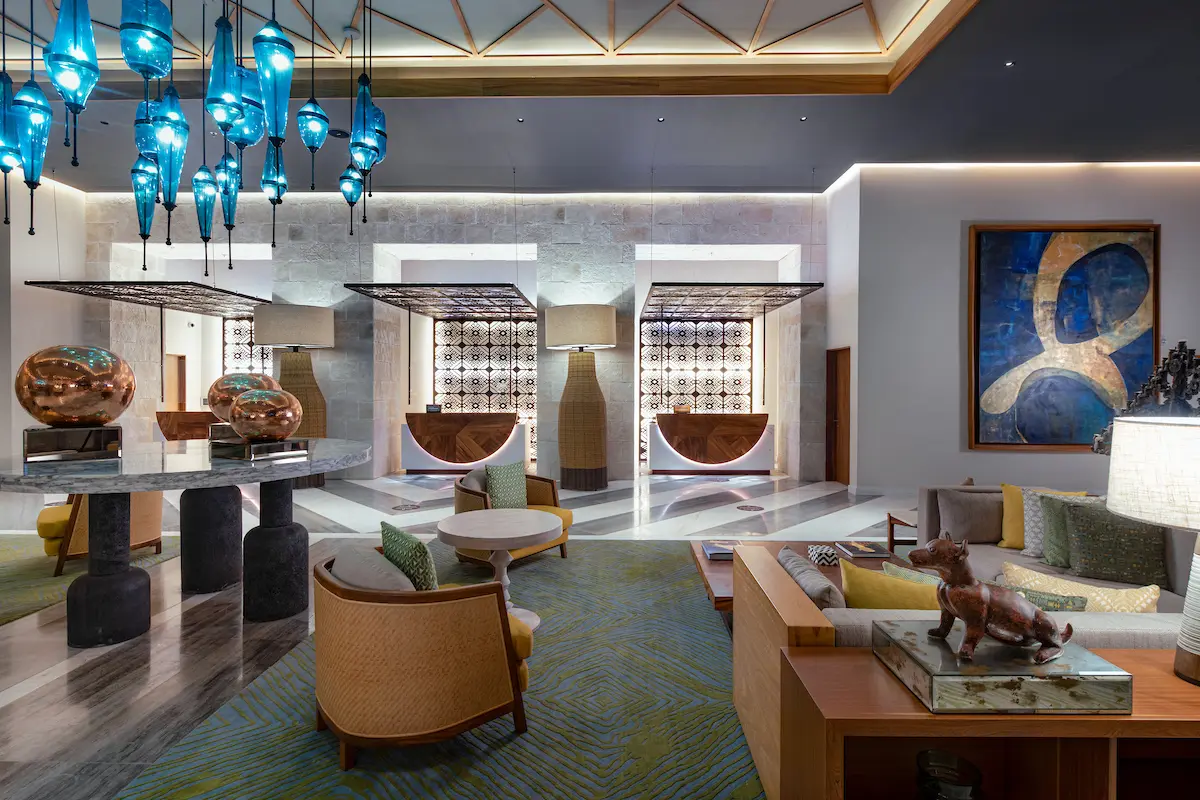 A meticulously organized living room boasts a sofa set and a captivating chandelier.