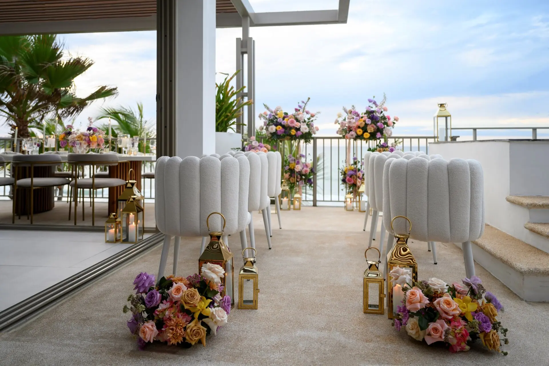 The balcony is beautifully decorated for the wedding celebration, offering a sea view.