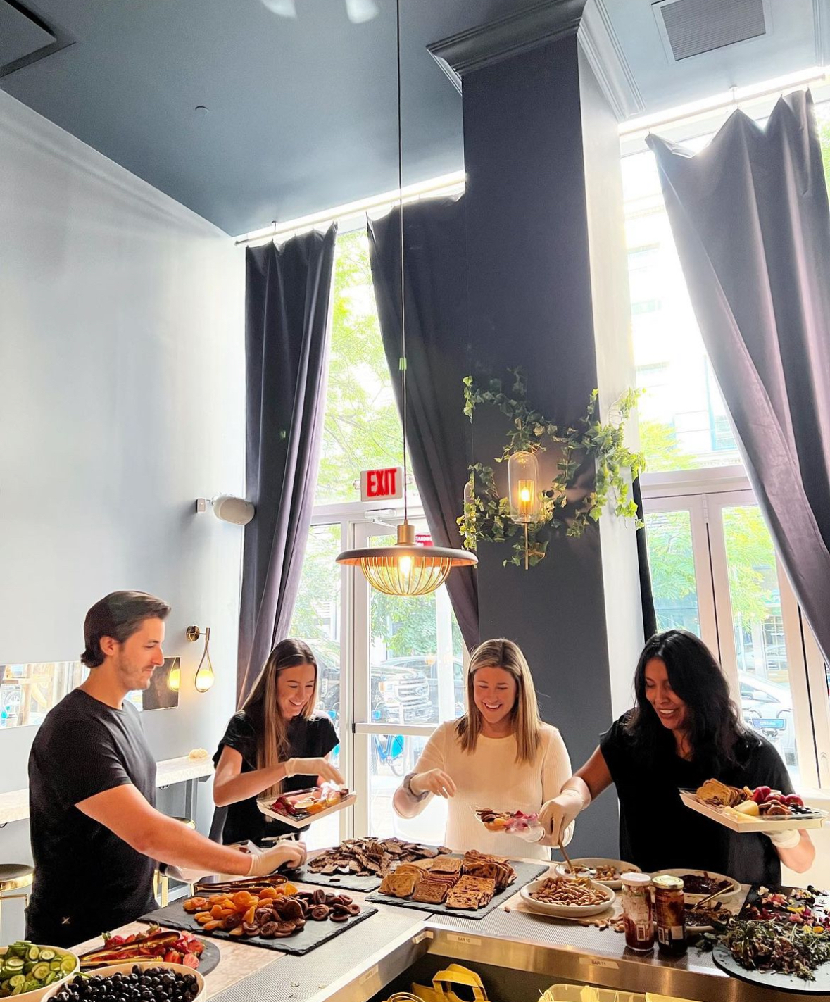 People are enjoying dinner together at the buffet, savoring various delicious dishes.