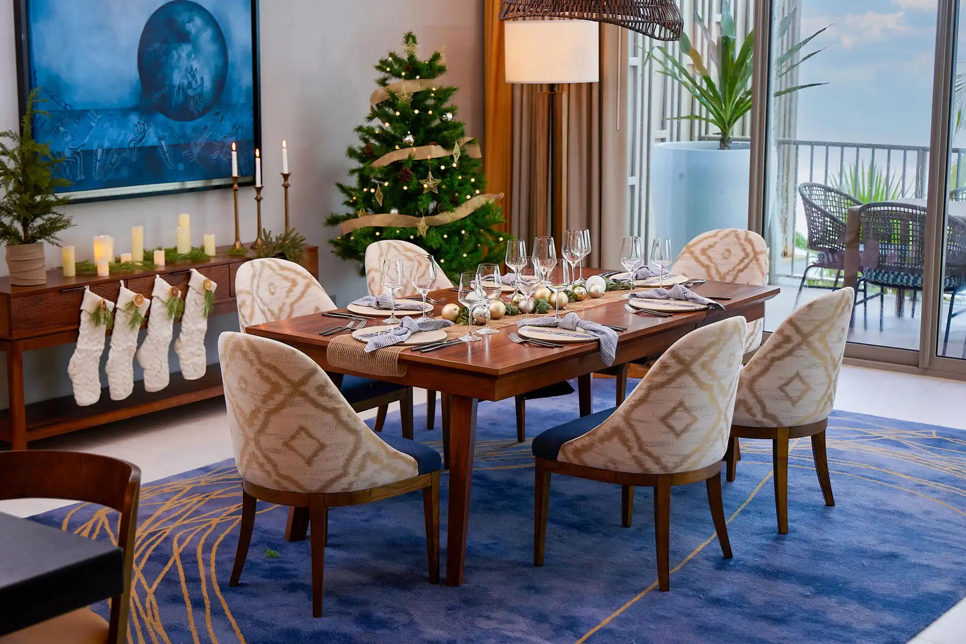 A beautifully arranged long dining table with crockery is set, ready for Christmas celebration.