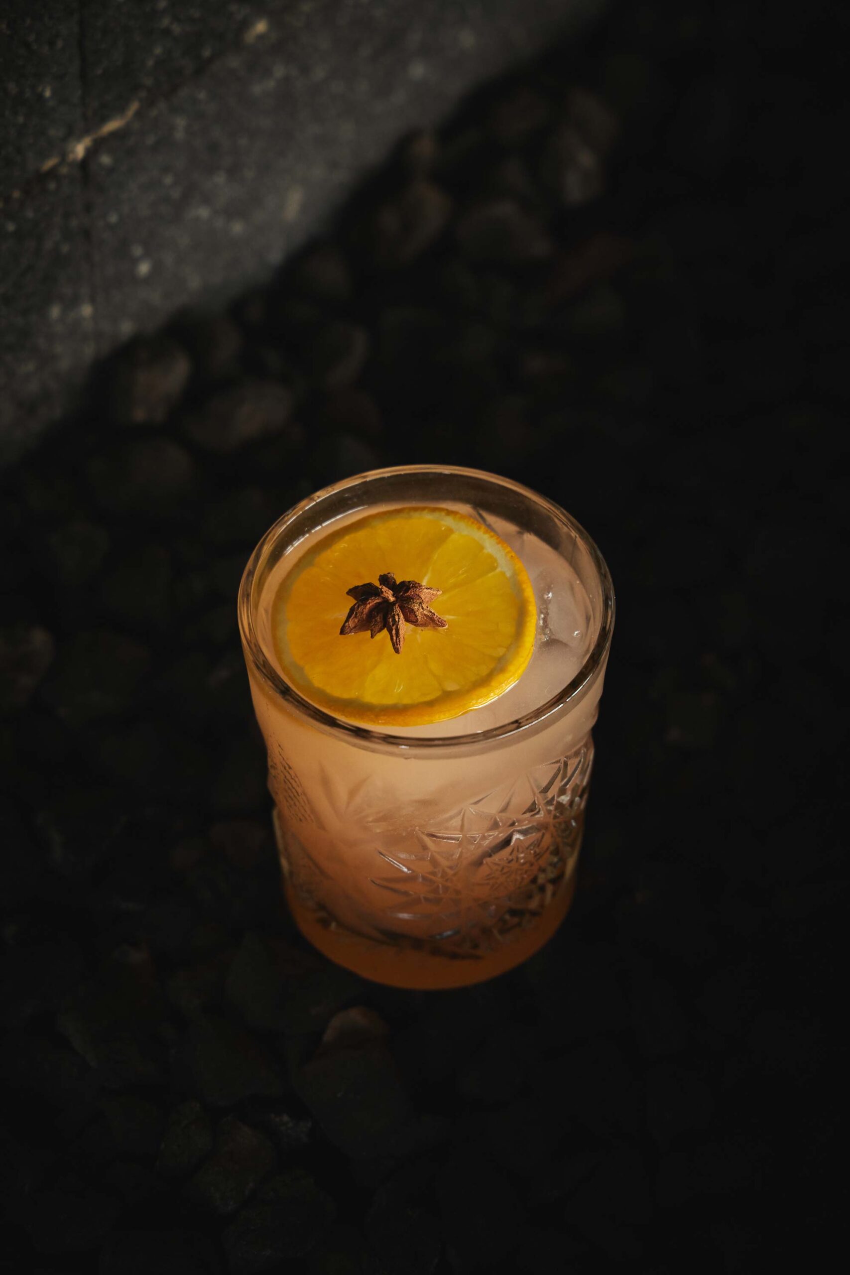 A glass of lemonade sits elegantly on the black table, ready to be enjoyed.