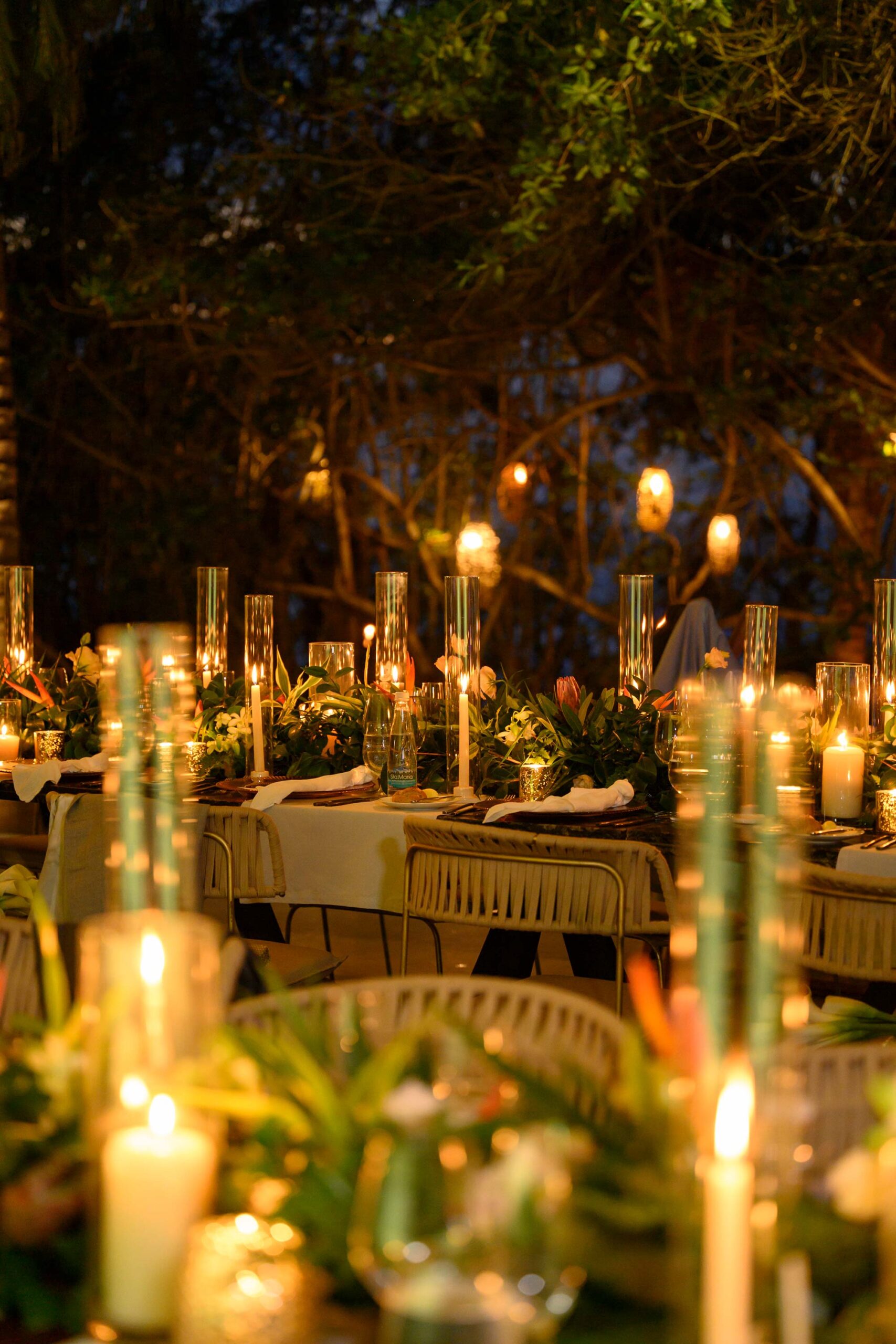 Tables are elegantly decorated with flowers and candles for the wedding celebration.